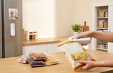 SnapSeal Mini Bag Sealer in White - in use sealing chips bag